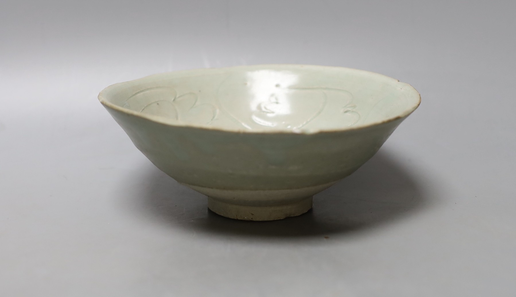 A Chinese incised celadon shipwreck bowl, Song/Yuan dynasty - 16.5cm diameter